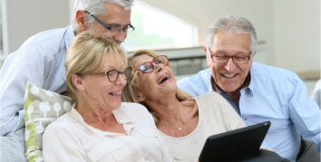 group of senior friends using digital tablet